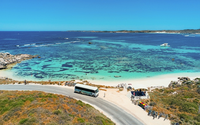 Tourists on a bus tour at Rottnest Island with coastline view, Perth or Fremantle return ferry.