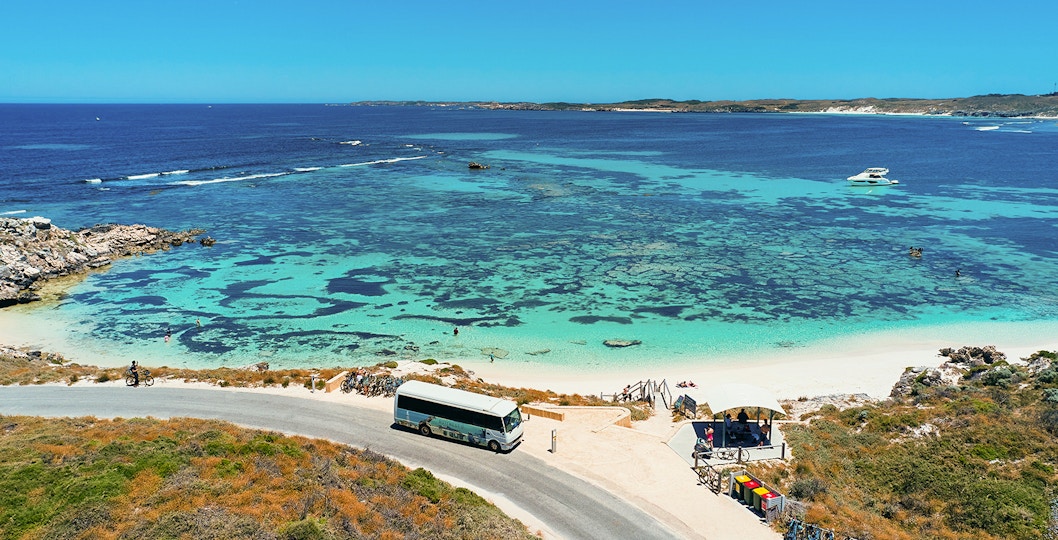 Tourists on a bus tour at Rottnest Island with coastline view, Perth or Fremantle return ferry.