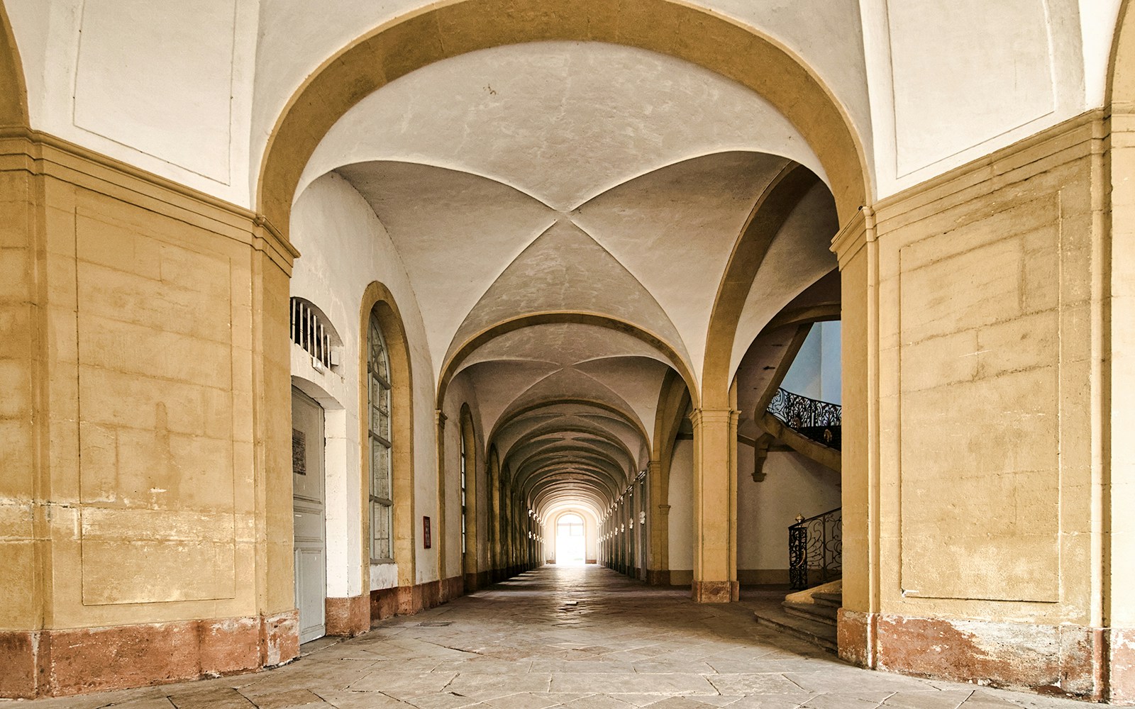 Interior arches of Abbaye de Cluny, Lyon, France, showcasing historic architecture.