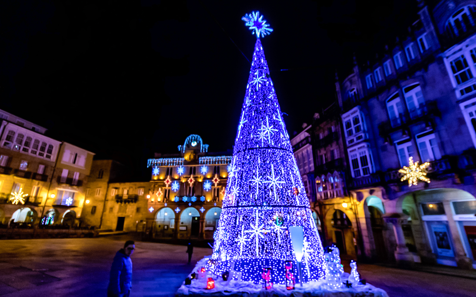 Eiffel Tower Christmas lights display 2025 with illuminated tree and festive decorations.