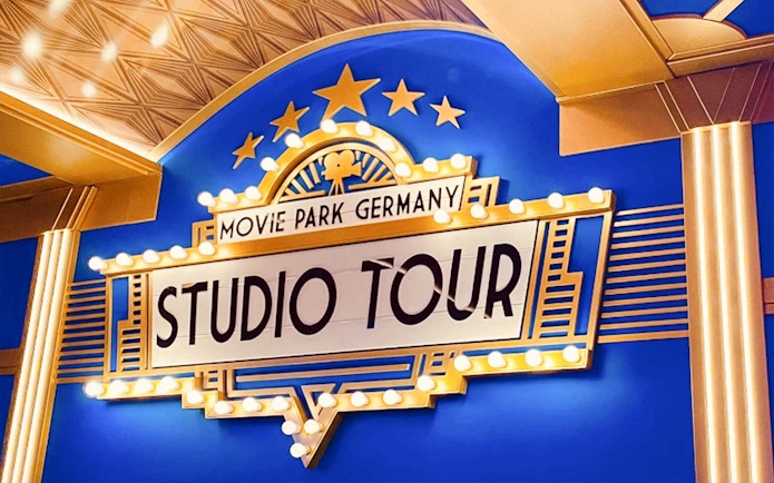 Movie Park Germany Studio Tour sign with lights and stars.