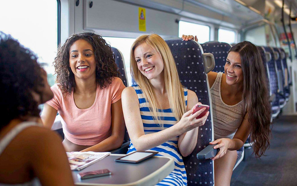 Women enjoying a conversation on the Stansted Express train.