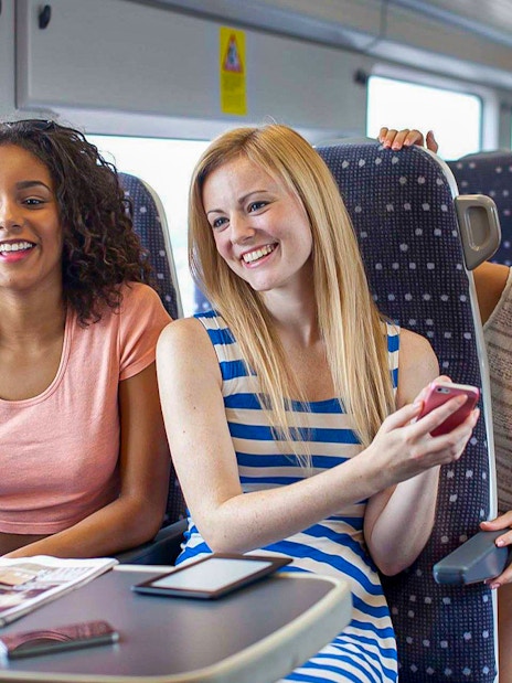Women enjoying a conversation on the Stansted Express train.