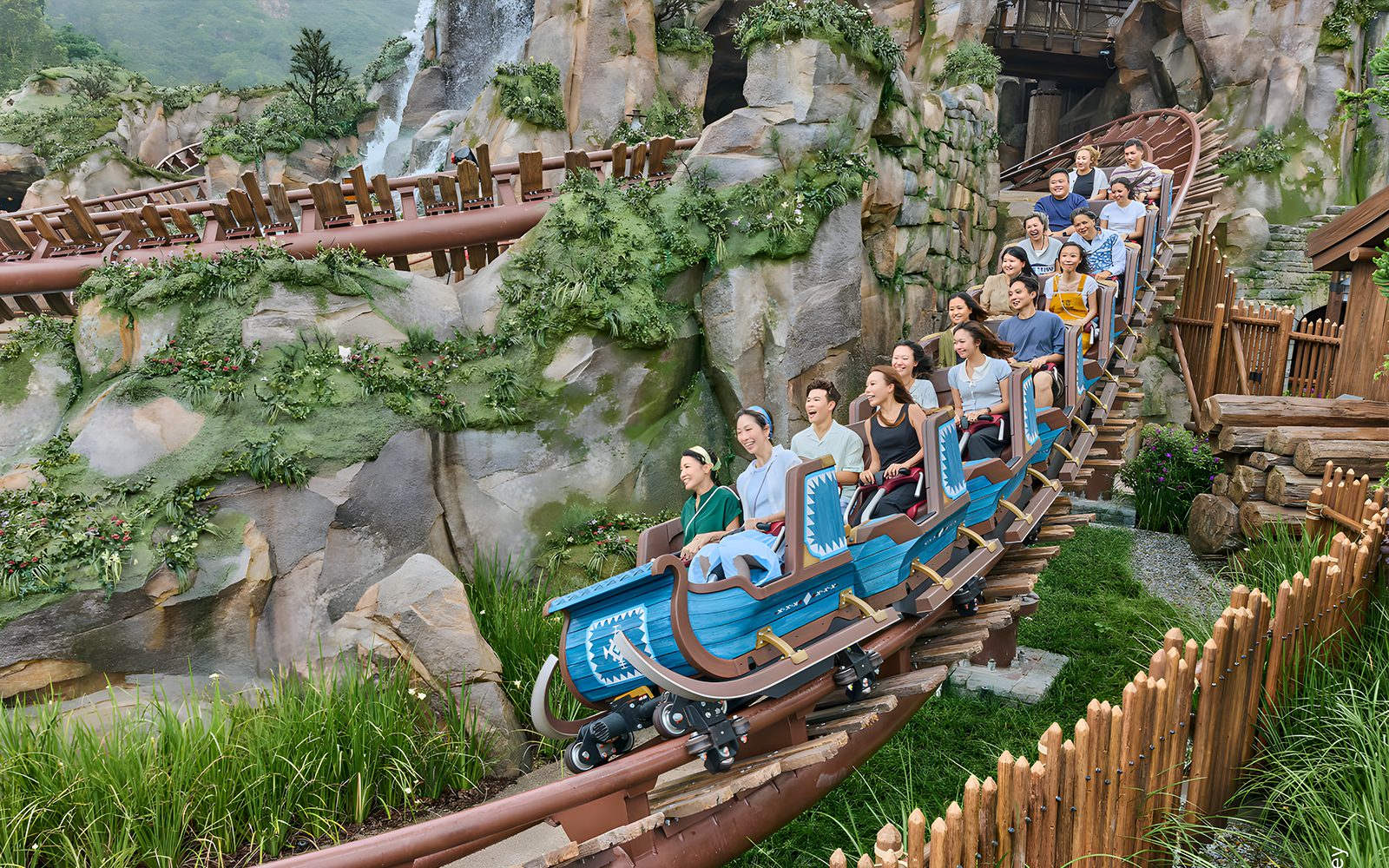 Roller coaster ride at Grizzly Gulch, Disneyland Hong Kong, with passengers enjoying the thrill.