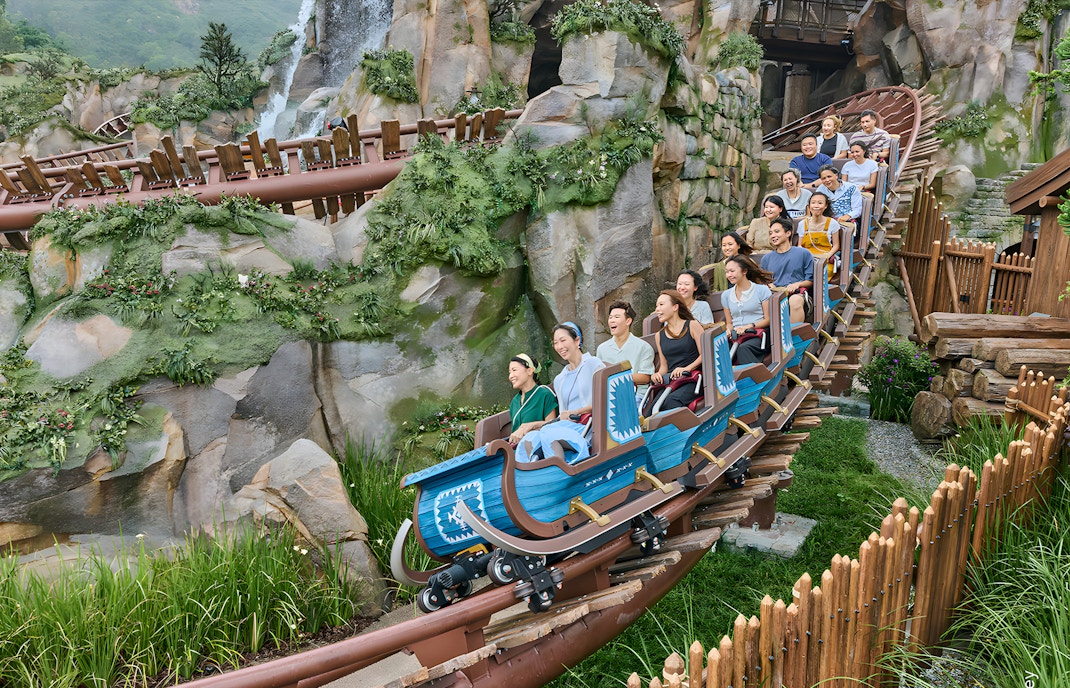Roller coaster ride at Grizzly Gulch, Disneyland Hong Kong, with passengers enjoying the thrill.