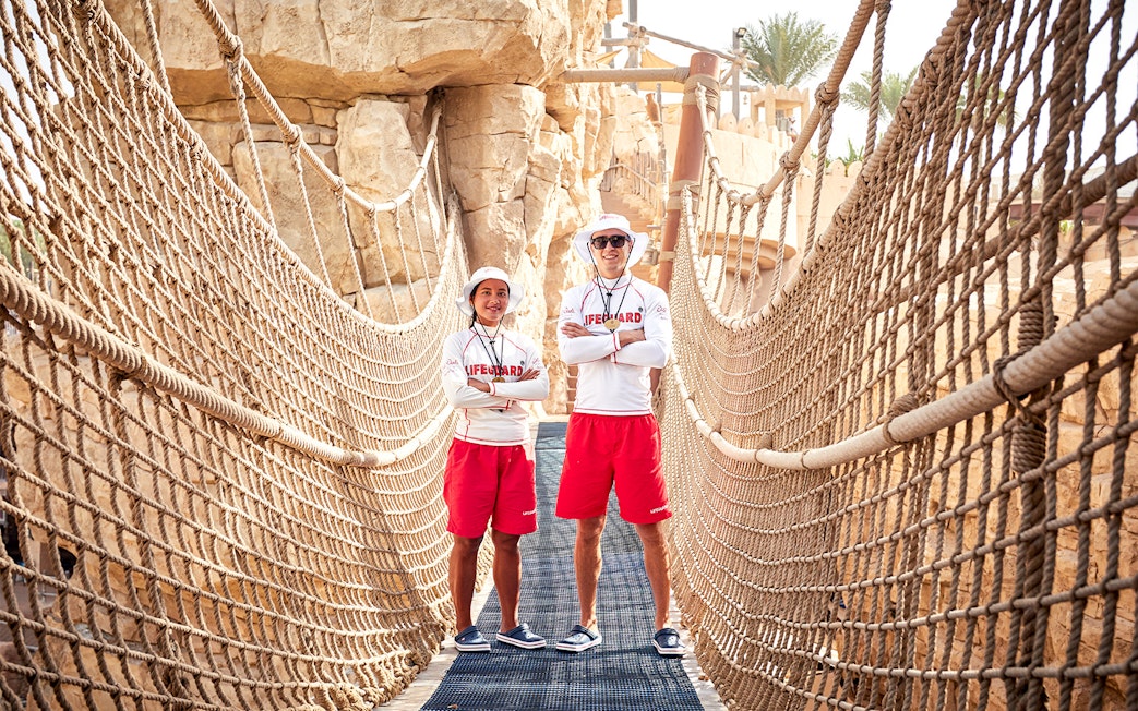 Lifeguards on a rope bridge at Wild Wadi Waterpark, Dubai.