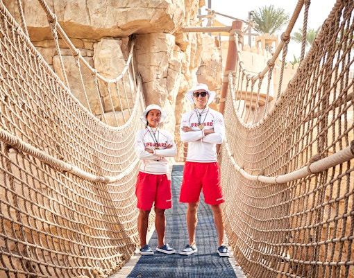 Lifeguards on a rope bridge at Wild Wadi Waterpark, Dubai.