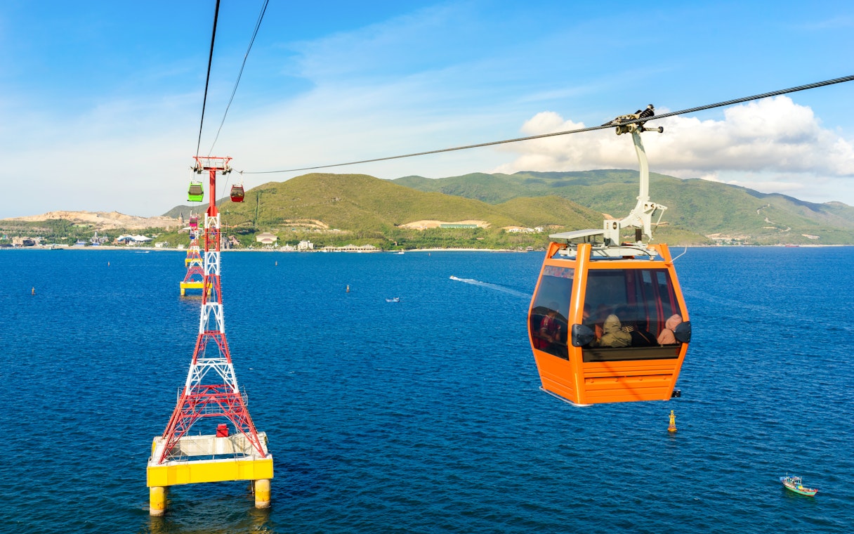 Cable car over ocean to Vinpearl, Nha Trang with mountains in background.