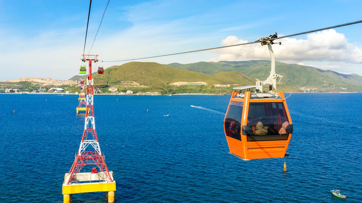Cable car over ocean to Vinpearl, Nha Trang with mountains in background.