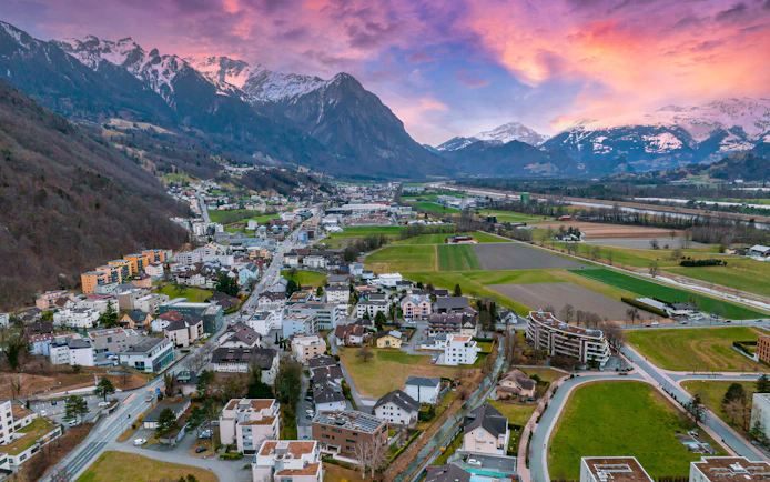 Aerial view of Vaduz, Liechtenstein with mountains and cityscape.