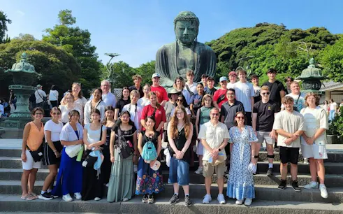 Group of tourists in front of the Great Buddha statue in Kamakura, Japan.
