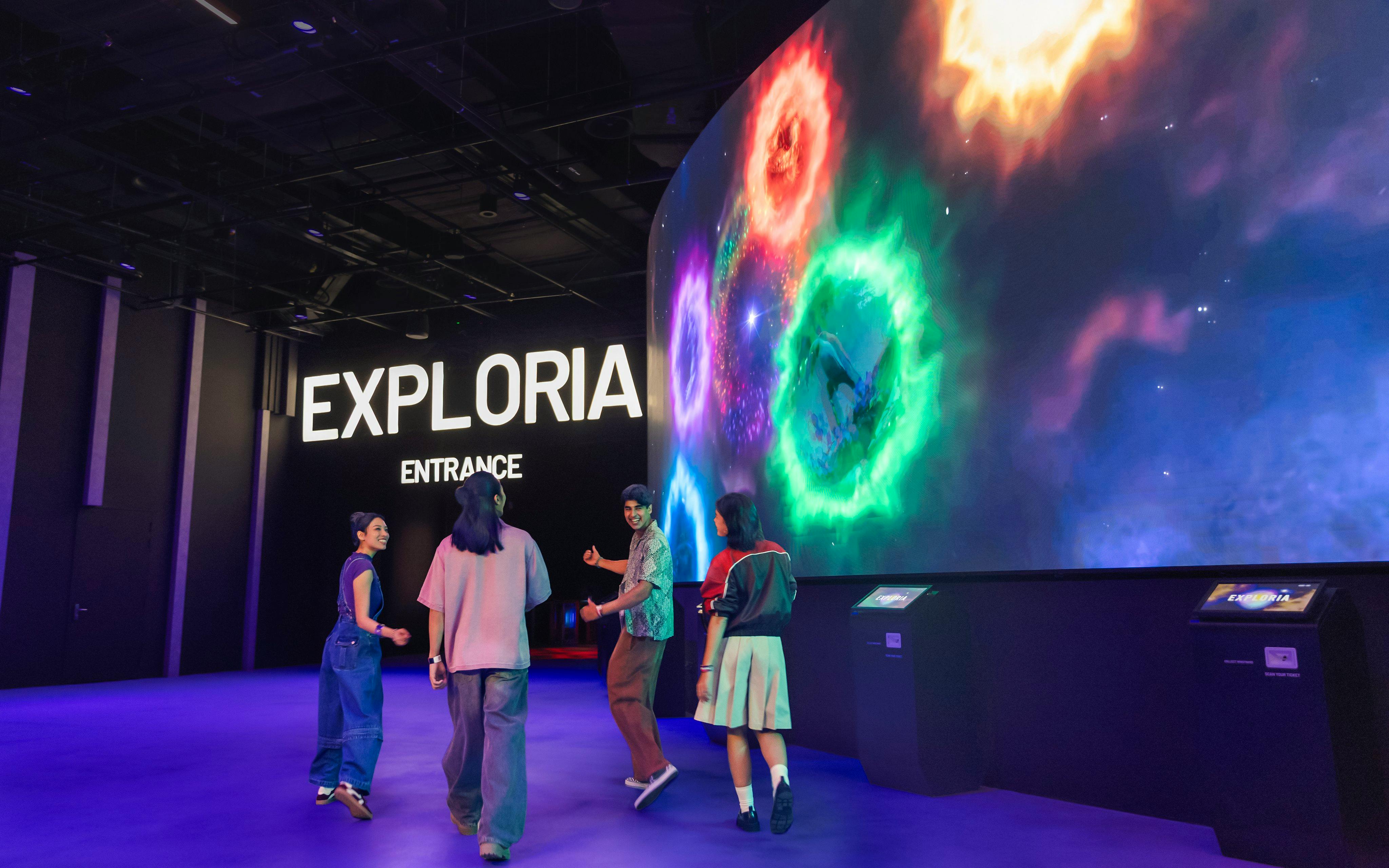 Visitors at Exploria entrance, Mandai Wildlife, viewing interactive cave spider exhibit displays.