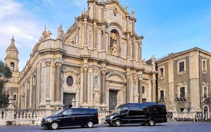 Savoca church with tour vans parked in front, part of Godfather sightseeing tour.
