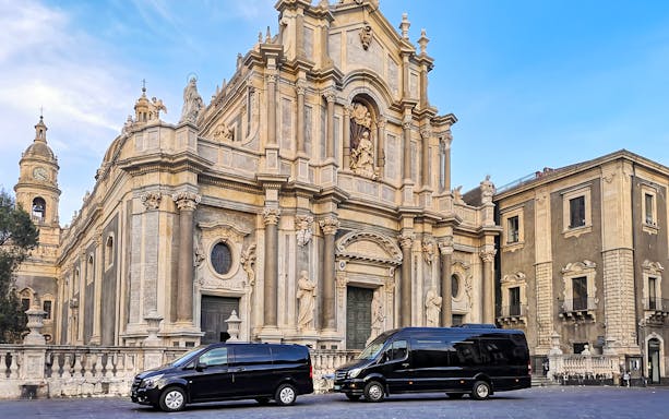 Savoca church with tour vans parked in front, part of Godfather sightseeing tour.