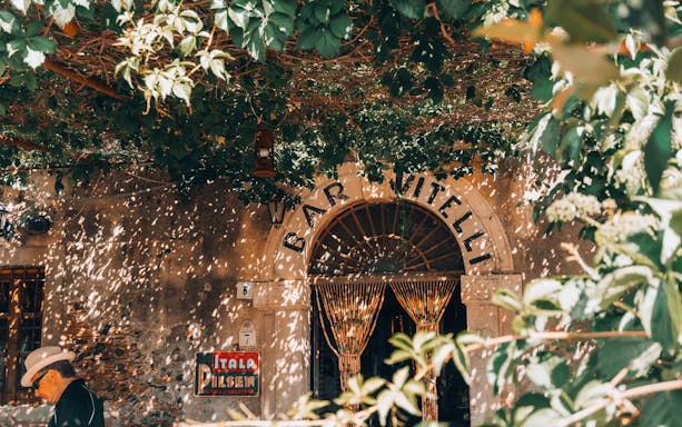 Bar Vitelli entrance with vintage decor, part of The Godfather Tour in Catania.
