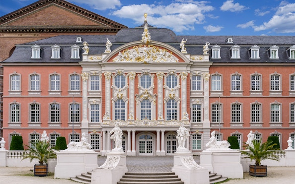 Baroque facade of the Electoral Palace in Koblenz, Germany, with ornate statues and decorative details.