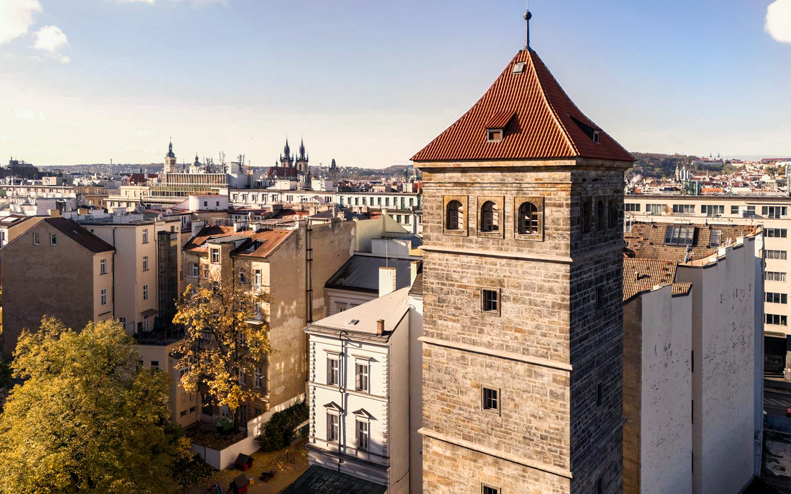 New Mill Water Tower in Prague with cityscape in the background.