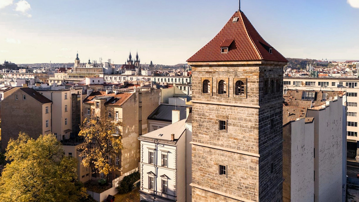 New Mill Water Tower in Prague with cityscape in the background.
