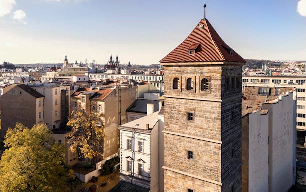 New Mill Water Tower in Prague with cityscape in the background.