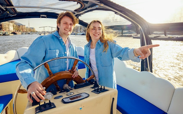 Staff steering the Smoke friendly Cloud Boat Cruise in Amsterdam.