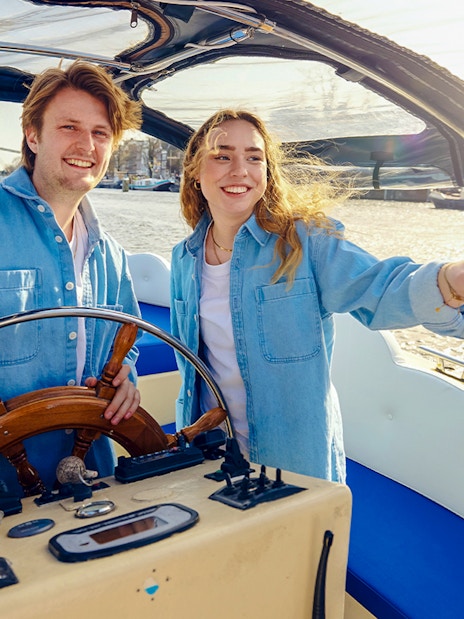 Staff steering the Smoke friendly Cloud Boat Cruise in Amsterdam.