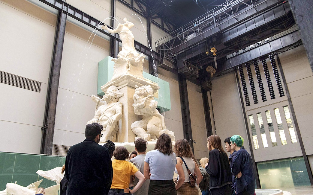 Visitors observing a large sculpture inside Tate Modern during the Discovery Tour.