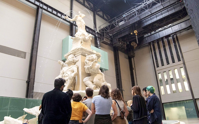 Visitors observing a large sculpture inside Tate Modern during the Discovery Tour.