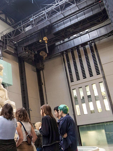 Visitors observing a large sculpture inside Tate Modern during the Discovery Tour.