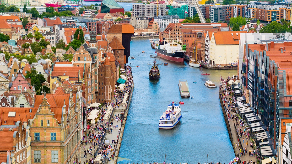 Galar Cruise ship sailing through the Motława River in Gdansk, surrounded by historic buildings.