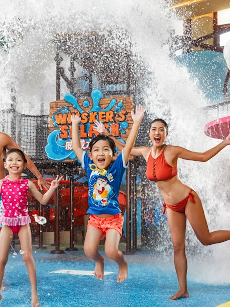 Family enjoying water play area at Ocean Park's Whiskers Splash, Hong Kong.