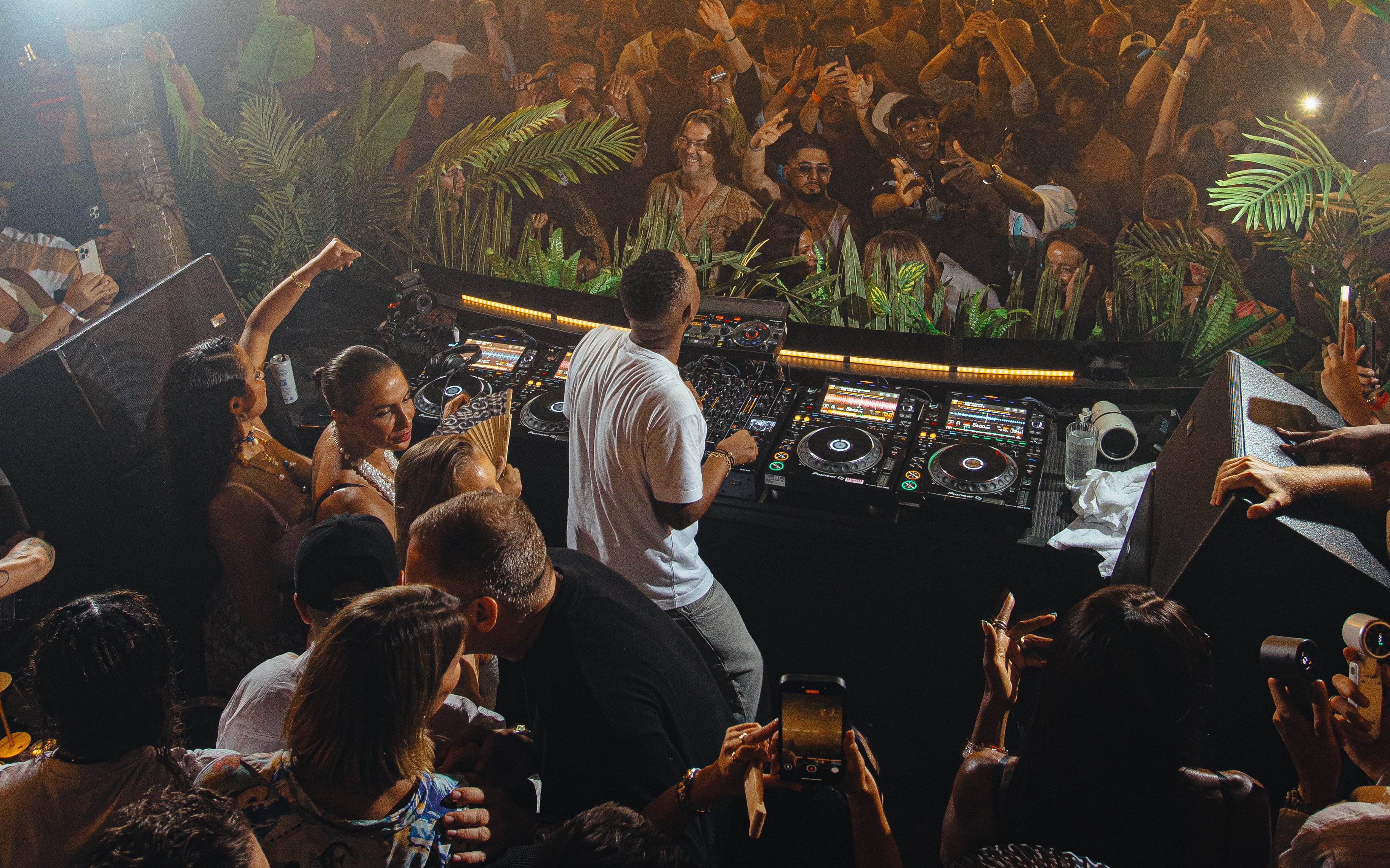 DJ performing at Club Chinois, Ibiza with crowd enjoying the music.