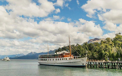 Boat docked on Lake Nahuel Huapi, journeying to Victoria Island and Arrayanes Forest.