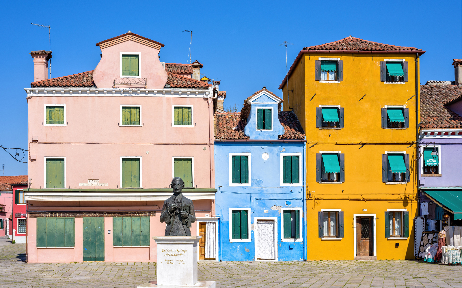 Daylight view to vibrant colorful city buildings facade at Galuppi Sqaure
