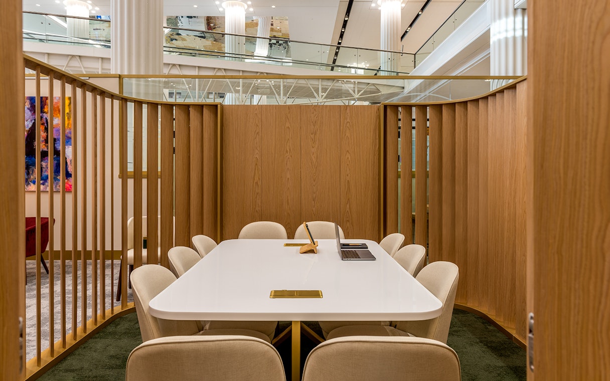 Premium lounge seating area at Dubai International Airport (DXB) with a conference table.