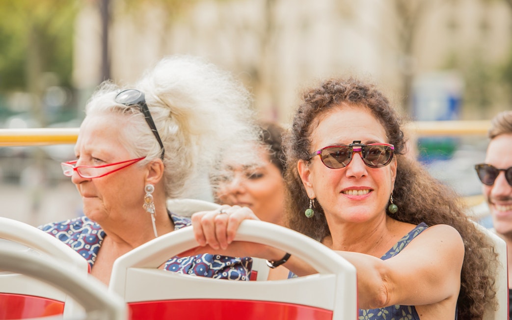 Tourists enjoying the view on a Munich hop-on hop-off bus tour.