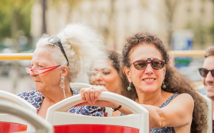 Tourists enjoying the view on a Munich hop-on hop-off bus tour.