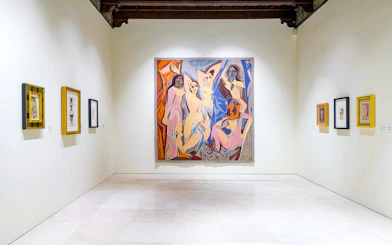Artworks displayed at the Picasso Museum in Malaga, featuring a large central painting.