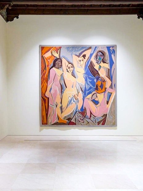 Artworks displayed at the Picasso Museum in Malaga, featuring a large central painting.