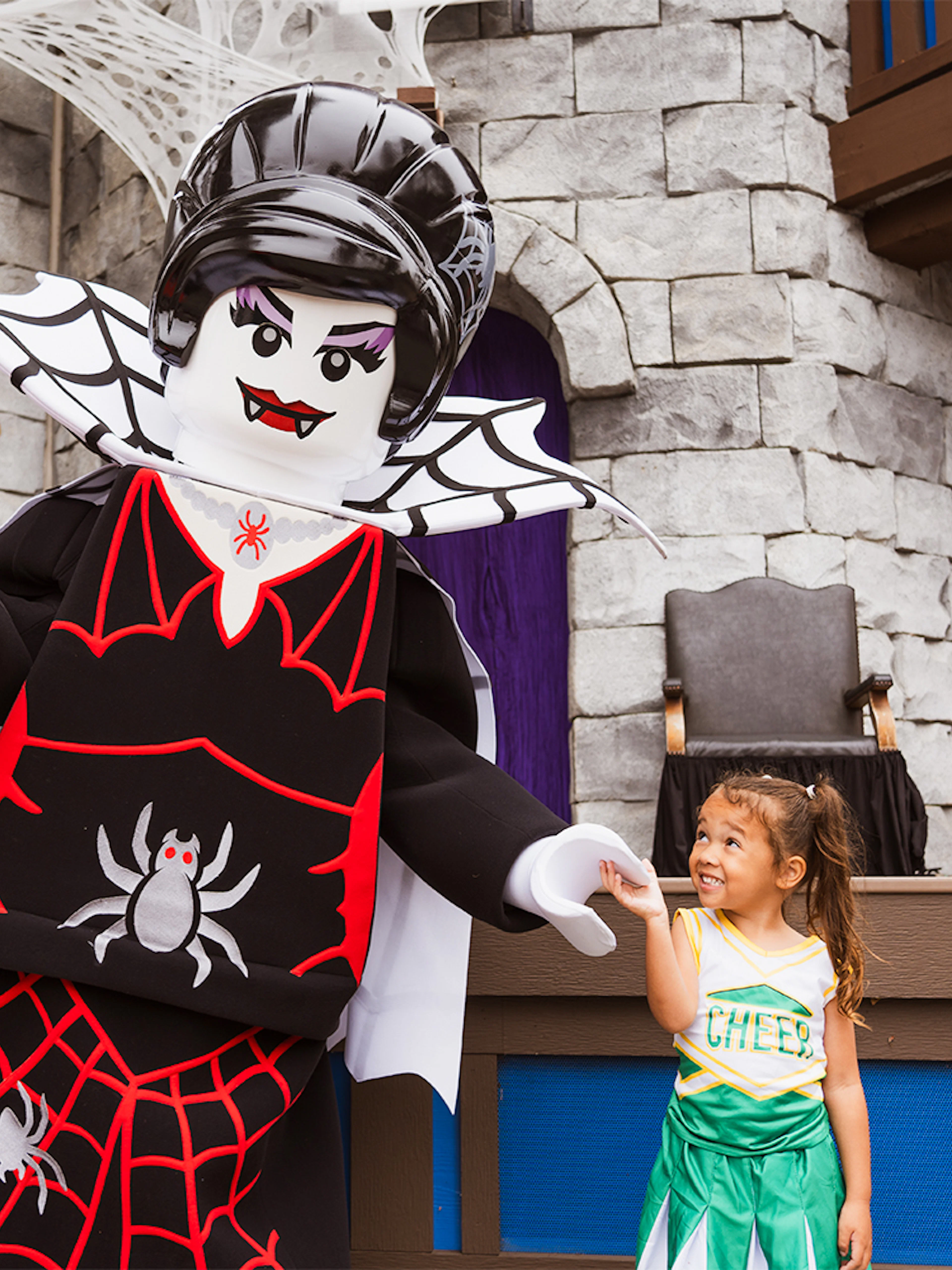 SpiderLady character at Brick or Treat event, Legoland Florida, interacting with a child.
