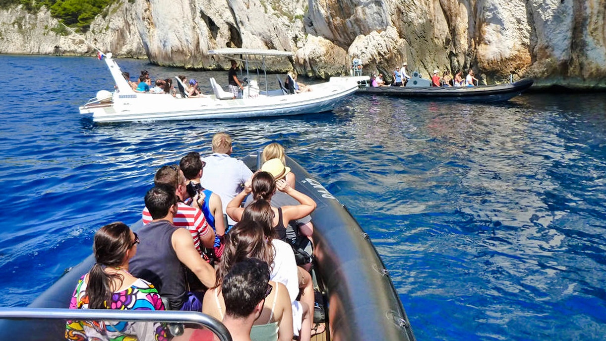 Speedboats with tourists near blue caves in Croatia.