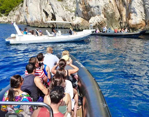 Speedboats with tourists near blue caves in Croatia.