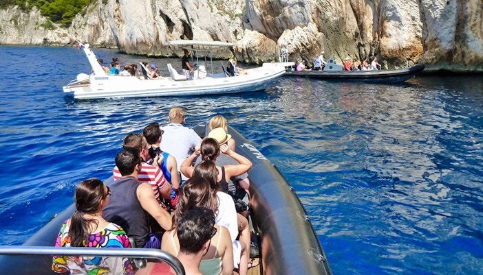 Speedboats with tourists near blue caves in Croatia.