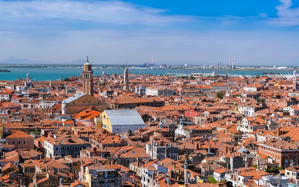 Aerial view of Venice rooftops with St. Mark’s Bell Tower in the distance, Italy.