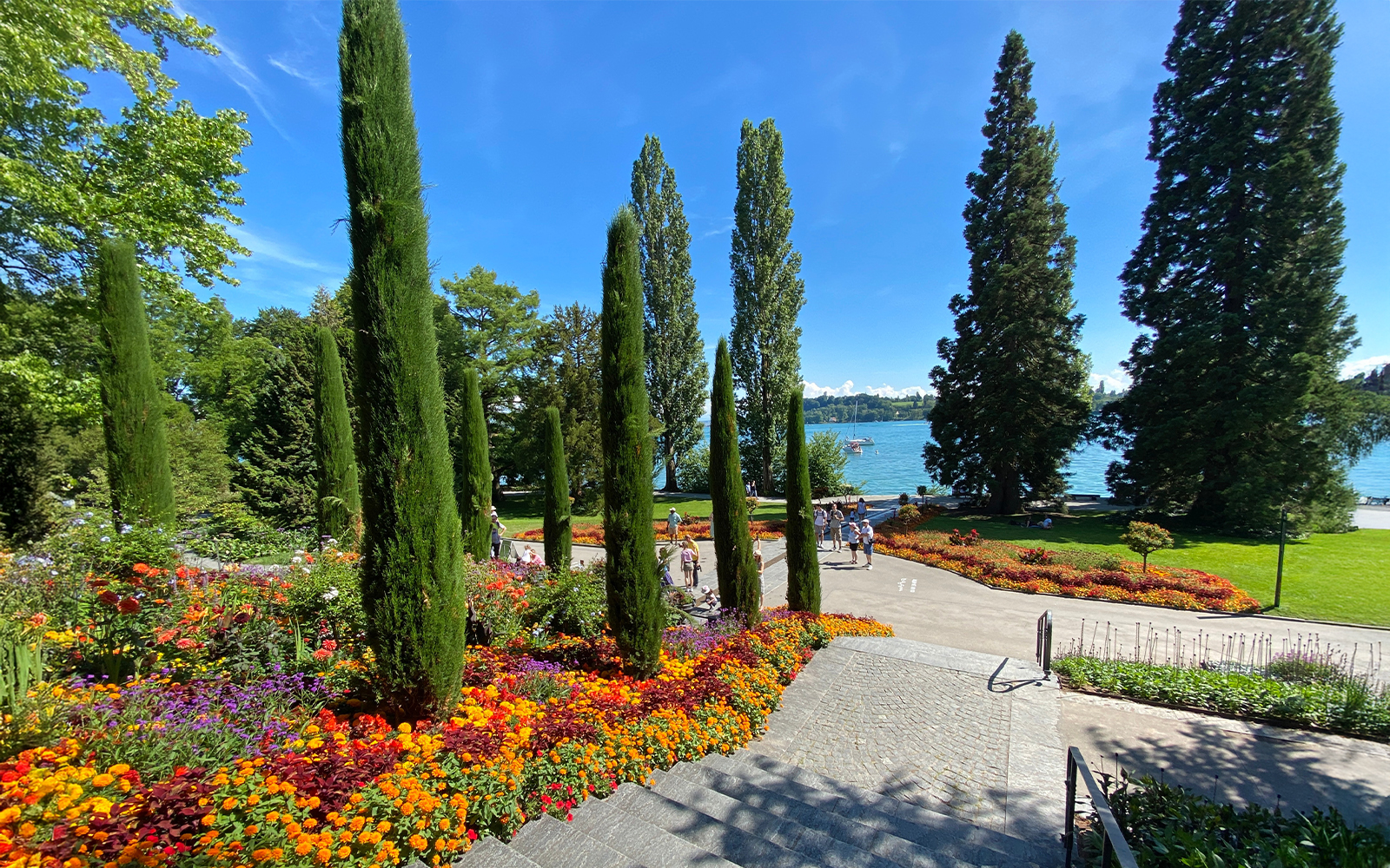 Mainau Flower Island Italian Floral Water Cascade landscape with vibrant flowers and lake view.