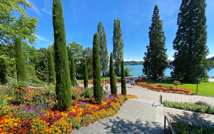 Mainau Flower Island Italian Floral Water Cascade landscape with vibrant flowers and lake view.
