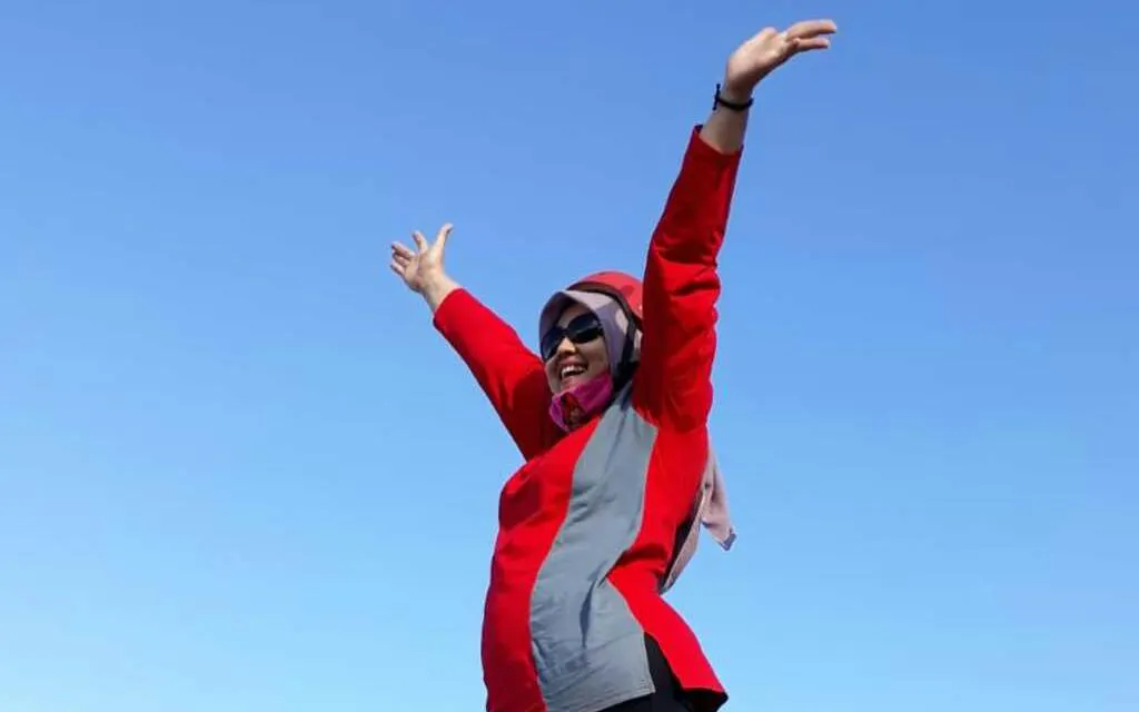 Person celebrating during Jeep Merapi Lava Tour at sunrise, Dubai.