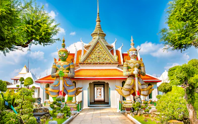 Wat Arun entrance with guardian statues, Bangkok.