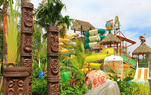 Amverton Riverine Splash water park with colorful slides and tiki totems.