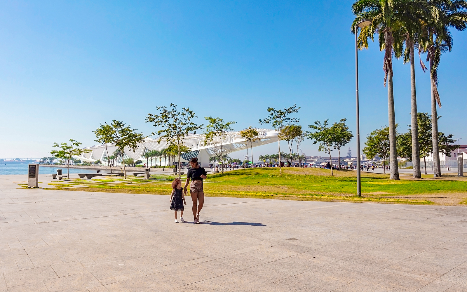 Mother and daughter walking near the Museum of Tomorrow in Rio de Janeiro, Brazil.