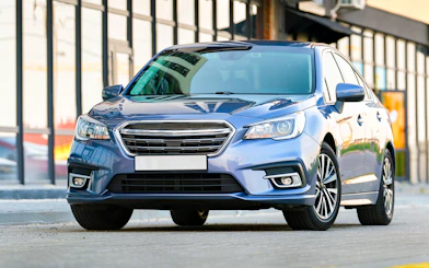 Business sedan parked for private airport transfer service.